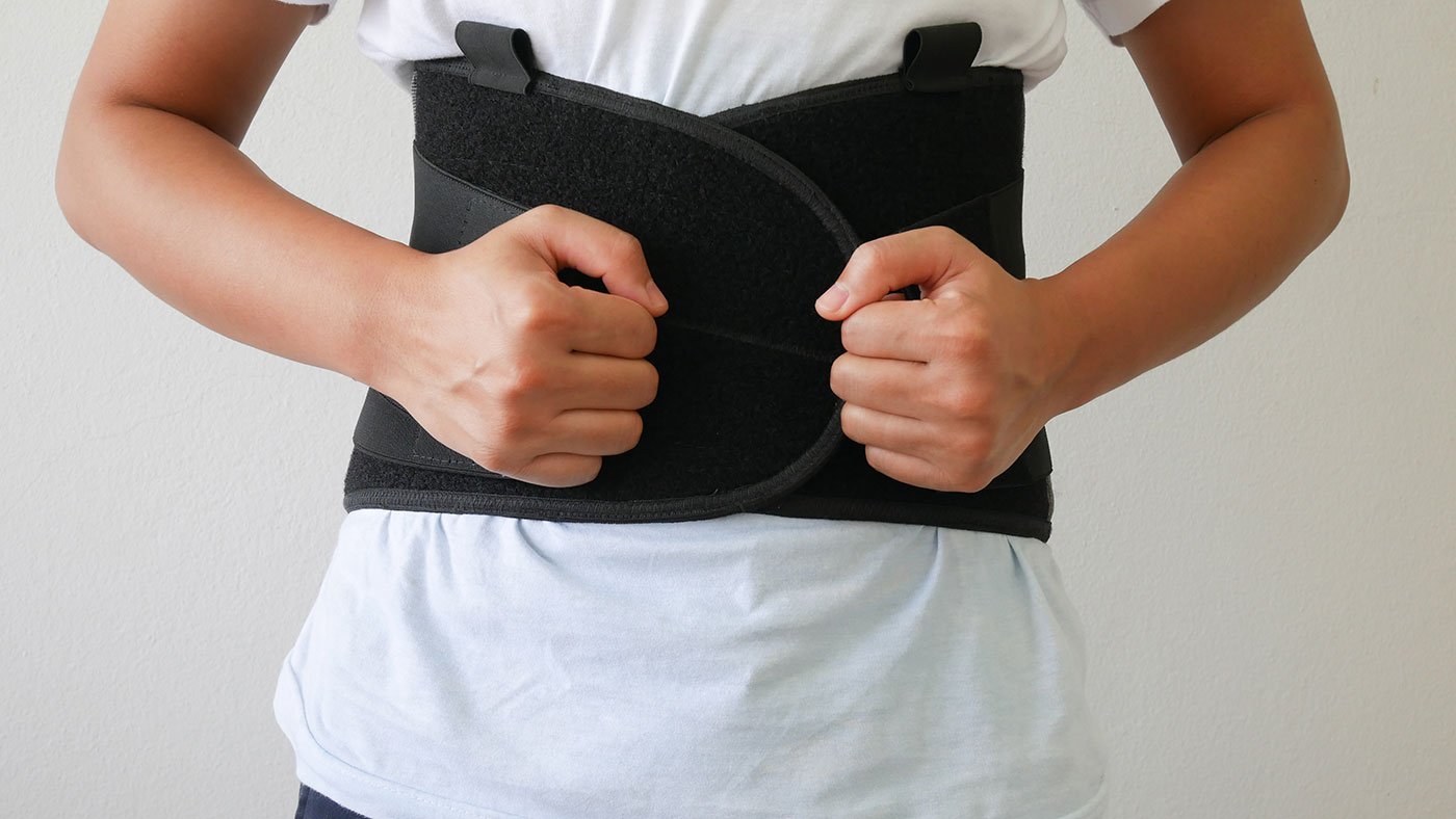Man with back brace, Can Back Braces Cause Muscle Weakness?