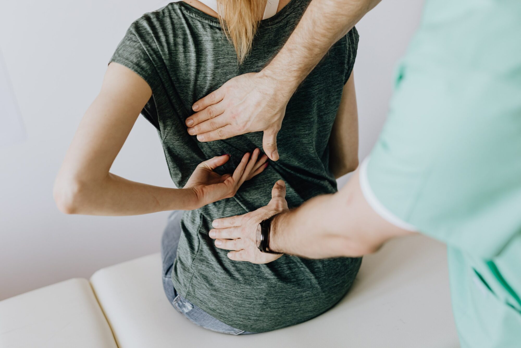 Chiropractor providing spinal adjustment to a patient