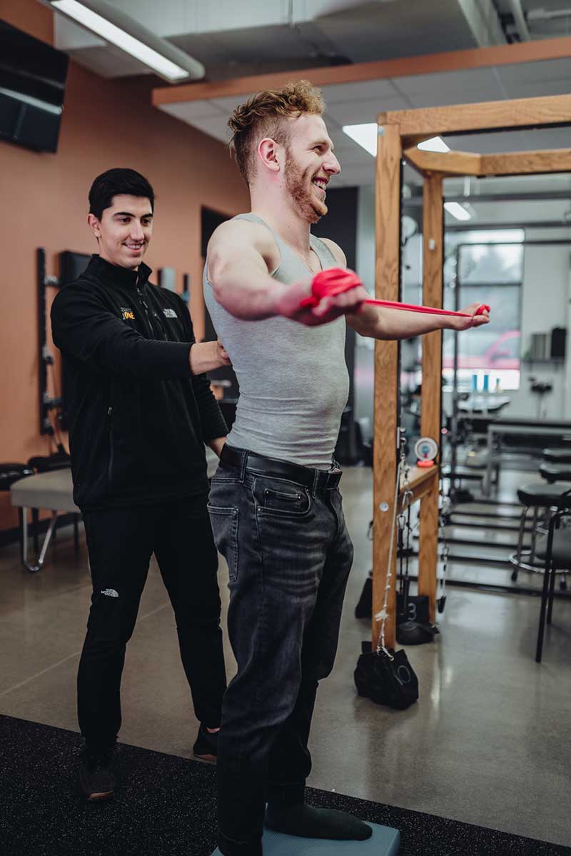 Male patient receiving shoulder rehab treatment at Square One Health